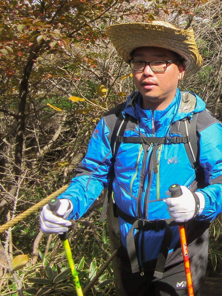 Korean hiker with walking sticks