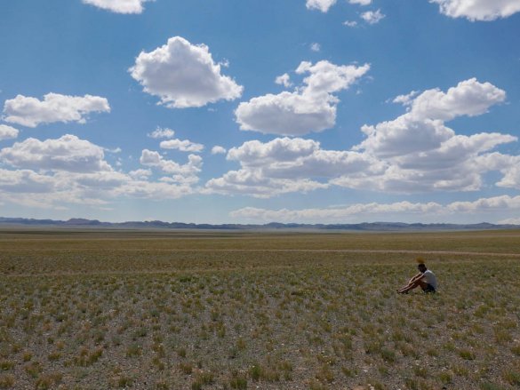 Rick sitting in the vast landscape in the Gobi desert